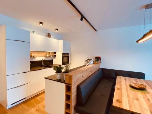 a kitchen with a couch and a table in a room at Ferienwohnung Talbach in Schladming