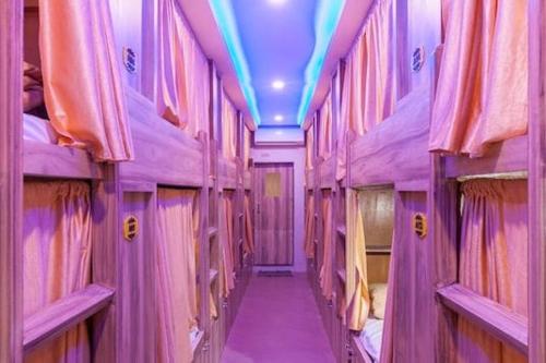 a purple room with bunk beds and a purple ceiling at New Abza Dormitory in Mumbai