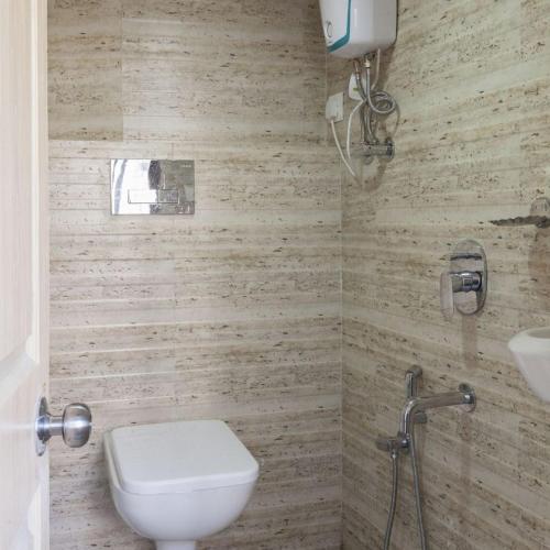 a bathroom with a toilet and a sink at New Abza Dormitory in Mumbai