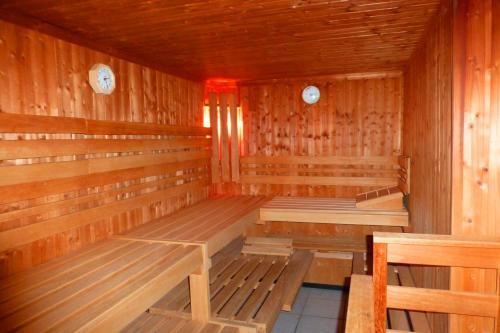 a empty wooden sauna with wooden benches in it at Hotel Meeresburg in Norderney
