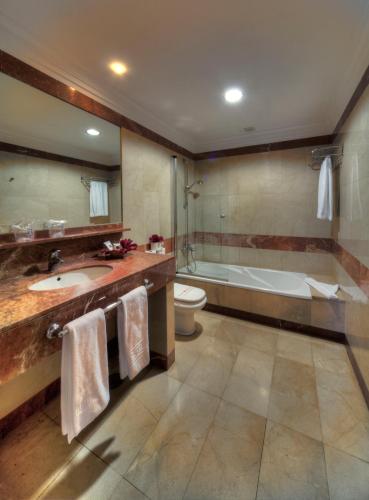 a bathroom with a sink and a tub and a toilet at Las Marismas de Corralejo in Corralejo