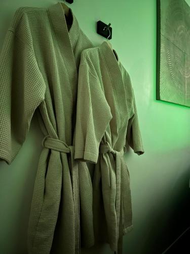 a robe is hanging on a wall at Détente & Spa in Villers-Allerand