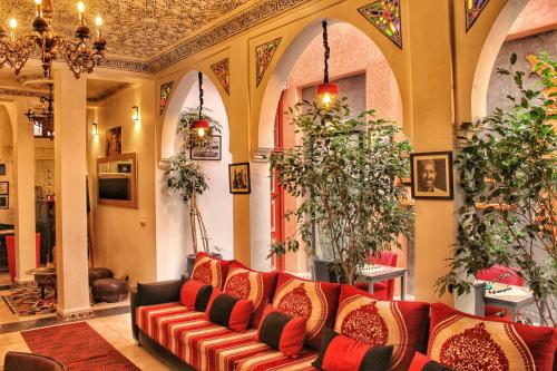 Riad Arabic House & Spa في مراكش: غرفة معيشة بها أريكة وبعض النباتات