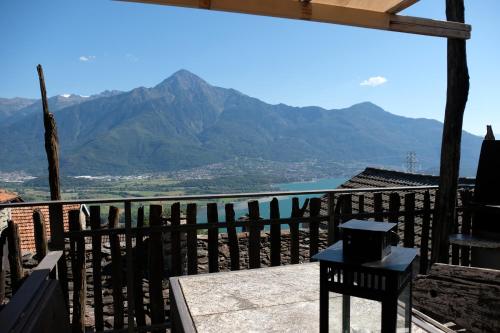 a balcony with a view of the water and mountains at Appartamenti Montemezzo Le Case in Pietra in Sorico
