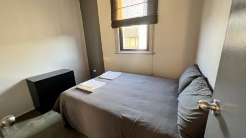 a small bedroom with a bed with a window at Heritage Hotel Rockhampton in Rockhampton