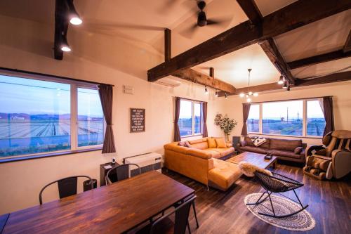 a living room with a couch and a table at Yadoya YADOKARI in Pippu