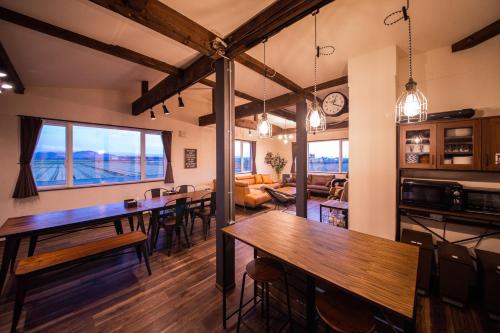 a room with tables and chairs and a living room at Yadoya YADOKARI in Pippu