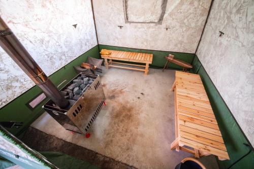 an overhead view of a room with a stove and a bench at Yadoya YADOKARI in Pippu