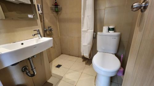 a small bathroom with a toilet and a sink at Studio17 Elpis Kemayoran JIEXPO Sunrise View -Min Stay 3 nights- in Jakarta