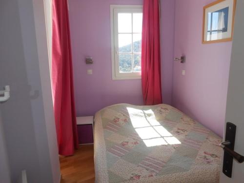 a bedroom with a bed with red curtains and a window at CAP ESTEREL, MAGNIFIQUE VUE MER PANORAMIQUE, TERRASSE, accès PISCINES, PARKING, dernier étage, classé 3 étoiles in Saint-Raphaël