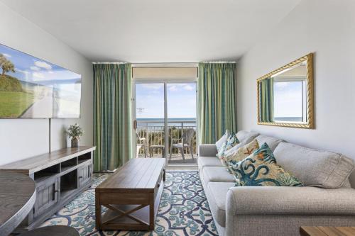 a living room with a couch and a table at Oceanfront Condo in Atlantica Resort near Boardwalk in Myrtle Beach