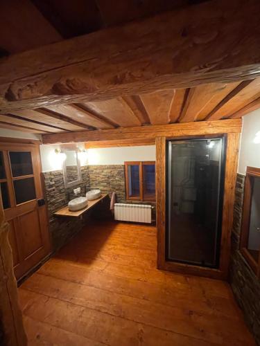 an empty room with a stone wall and wooden floors at Chalupa U Kocourka in Sedlec