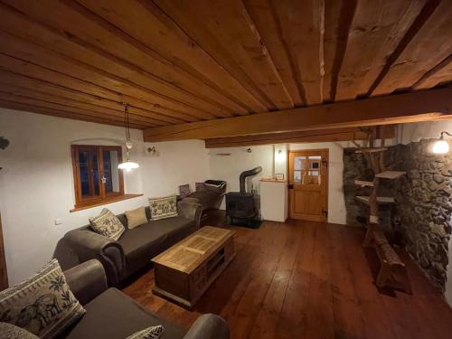 a living room with a couch and a table at Chalupa U Kocourka in Sedlec