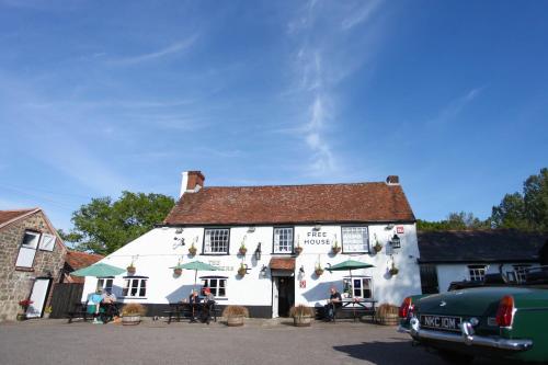 an old car parked in front of a white building at The Cricketers Arms in Petworth