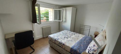 a small bedroom with a bed and a window at Cosy Appartement near Disneyland & Paris in Coupvray