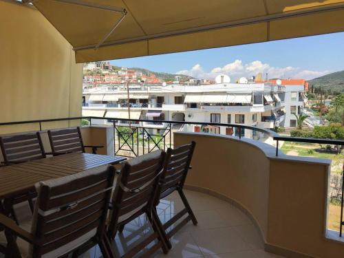 a balcony with a table and chairs and a view at Peramos Luxury in Nea Peramos