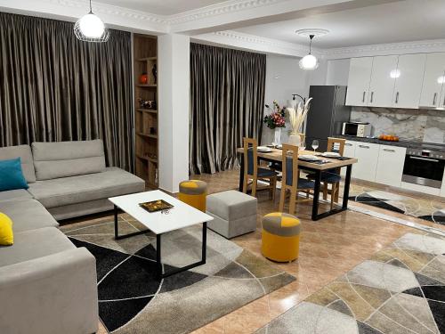 a living room with a couch and a table at Daily rent apartment city center Elbasan 6 in Elbasan