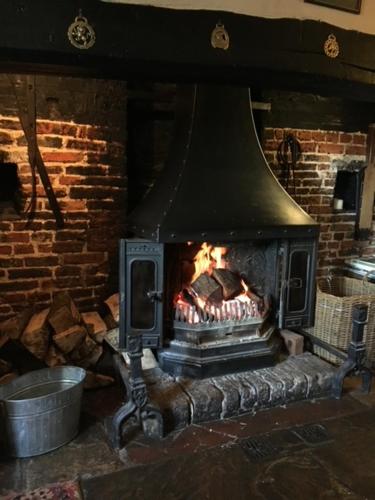 a brick oven with a fire in it at The Cricketers Arms in Petworth