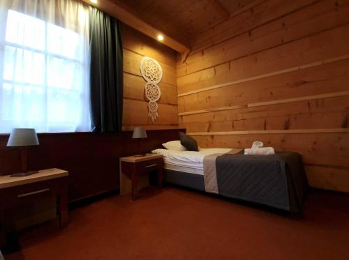 a bedroom with a bed in a wooden room at Hotel 365 in Kielce