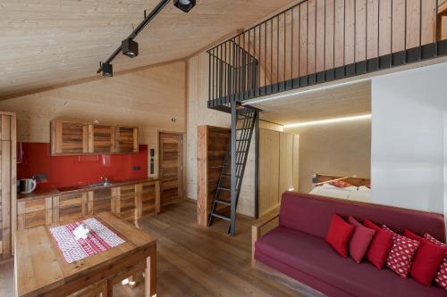 a living room and kitchen with a loft bed at Bros Hof in Malles Venosta