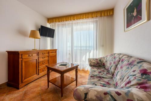 a living room with a couch and a table at Guest House Agava in Crikvenica