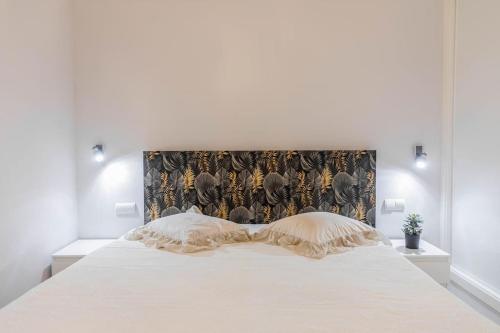 a large white bed in a white bedroom at Azahara 1 2B in Marbella