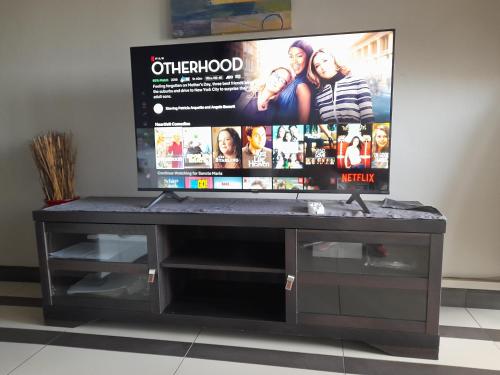 a entertainment center with a flat screen tv on top at Sancta Maria 10 - Ultimate in luxury & majestic sea views includes private entertainment deck - Free wifi in Kingsburgh