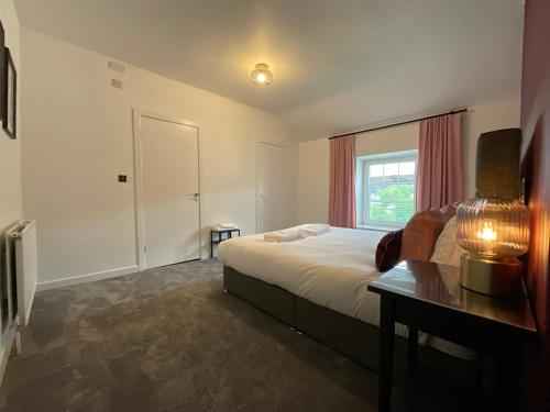 a hotel room with a bed and a window at Large 4 double bedroomed townhouse in central Holmfirth in Holmfirth