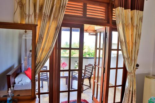 a room with a door open to a living room at Esprit Bentota in Bentota