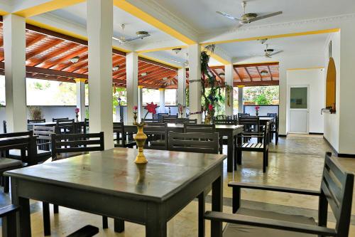 a dining room with tables and chairs in a restaurant at Esprit Bentota in Bentota