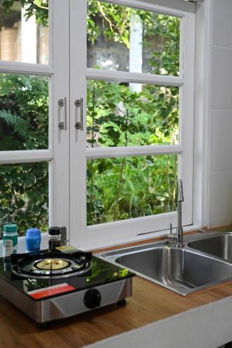 a kitchen with a sink and a window at Bao Village in Haad Yao