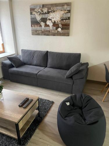 a living room with a couch and a coffee table at Chez Tikaf in Saint-Claude