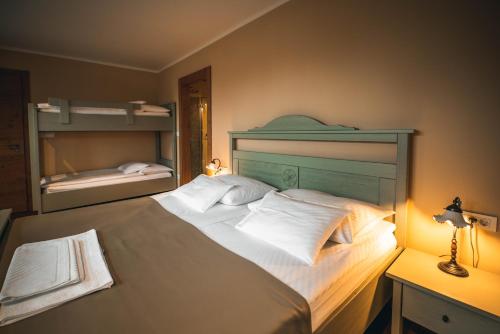 a bedroom with a large bed and a mirror at Hotel Zamorc in Škofja Loka