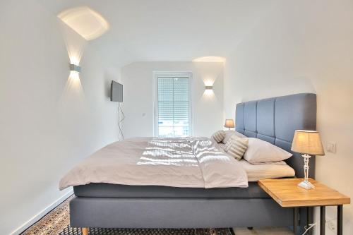 a bedroom with a large bed and a table at Haus Oberdeck 1 in Scharbeutz