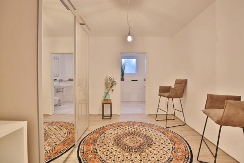 a living room with a glass door and a rug at Haus Oberdeck 1 in Scharbeutz