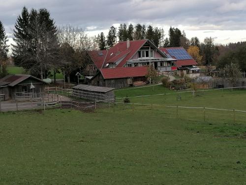 a large house with a green field in front of it at Spehnerhof in Vogt