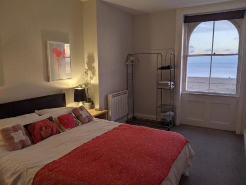 a bedroom with a bed with a view of the ocean at 3BD Coastal Retreat with Spectacular Sea Views in Folkestone