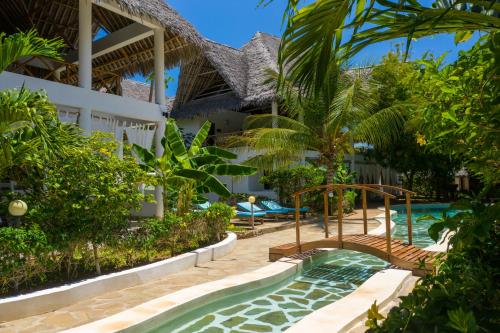 a pool at a resort with a swimming pool at Rafiki Village in Watamu