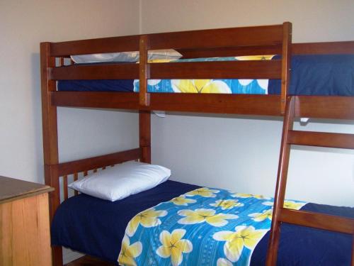 a bedroom with two bunk beds with a blue bed at Pebble Shack in Coles Bay