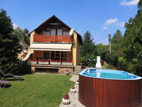 a house with a swimming pool in the yard at Aranyhal Vendégház in Sukoró