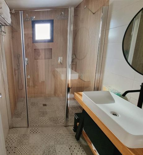 a bathroom with a shower and a sink at אתיטיוד בערבה attitude at the arava in H̱aẕeva
