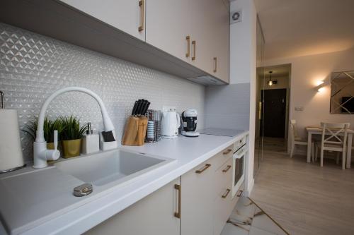 a kitchen with a sink and a counter top at Apartament in Bochnia