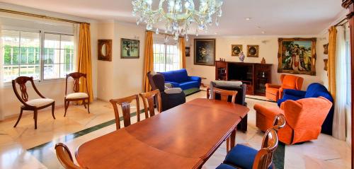 a living room with a table and chairs at Golden Villa Costa del Sol - Big Private Pool - BBQ - Good Location in Fuengirola