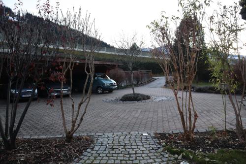 a car parked in a parking lot with trees at Landhaus-Appartements Warraich in Schladming