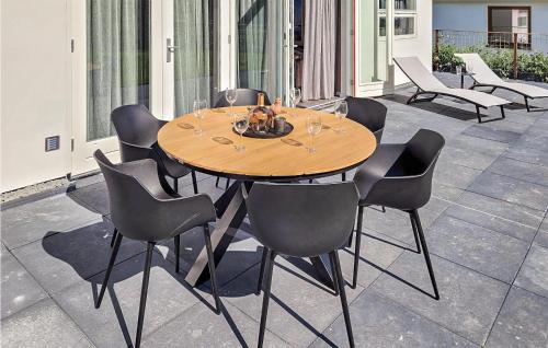 a wooden table and chairs on a patio at Rottummeroog in Den Oever