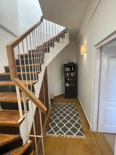 a hallway with a staircase and a door to a room at The Lodge at Wah, Kandbari in Pālampur