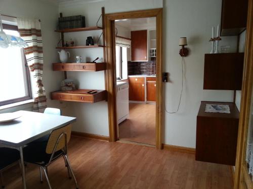a kitchen with a door open to a dining room at Guesthouse Hugo in Sørvágur