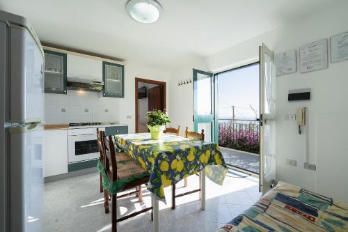 a kitchen and dining room with a table and a view at Torre di Amalfi - holiday house in Amalfi