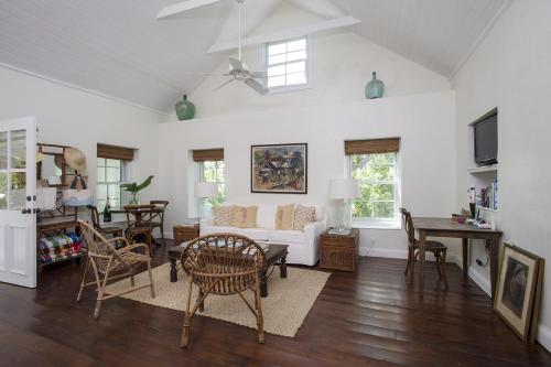 a living room with a couch and a table at Buccaneer Hill Cottage cottage in Governorʼs Harbour