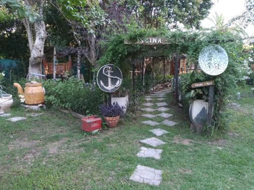 a garden with a sign and some plants at Pualy Resort & Spa in Belén de Escobar